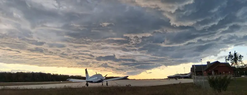 Island Airways and Fresh Air Aviation aircraft arriving at Beaver Island with rental car pickup